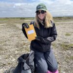 Sarah M., Wilder Institute Field Technician, after storing a voucher specimen of the moss campion (Silene acaulis) plant in an envelope for temporary preservation. This sample went on to be pressed, dried, mounted, and labelled, and is now within the collection at The Rooms Museum in St. John's, Newfoundland.